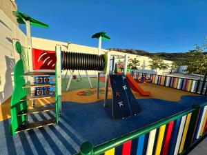a playground with a slide at La Villa de Alba - Casa Rural en Montefrío in Montefrío