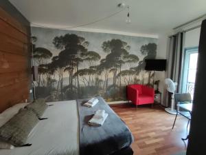 a bedroom with a bed with a mural of trees at Studio cosy centre historique Saint-Michel in Bordeaux