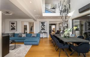 a dining room and living room with a blue couch and a table at Villa Bonavia in Zadar