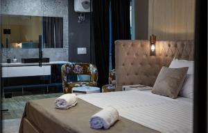 a bedroom with a large bed and a chair at Villa Lea in Zaton