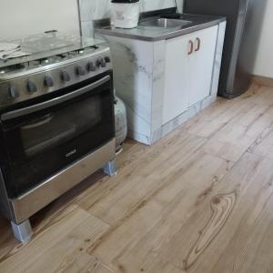 a kitchen with a stove and a sink at Green House Torres in Torres