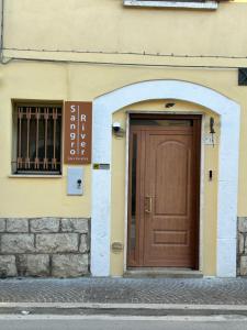 a building with a brown door on the side of it at Sangro River Casa Vacanza in Castel di Sangro