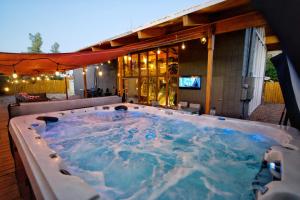 a large jacuzzi tub sitting on a patio at Las Vegas Oasis Home Primary in Las Vegas