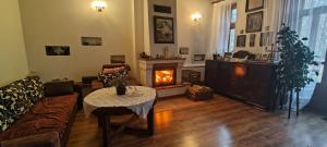 a living room with a couch and a fireplace at Kasztelania Pod Lipami in Zakroczym