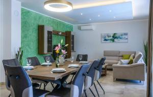 a dining room with a table and chairs at Santa Domenica in Rabac