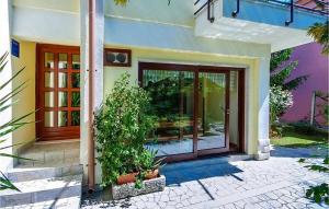 an entry to a house with glass doors and plants at Adorata 1 in Labin