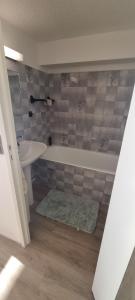 a bathroom with a tub and a sink at Studio Duplex 8 personnes Vue à couper le souffle in Saint-Honoré +4 photos