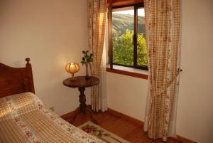 a bedroom with a bed and a window with a view at A TORRE no Sabugueiro in Sabugueiro