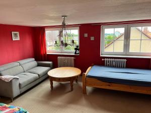 a living room with a couch and a bed at Unterkunft Dähre in Dähre