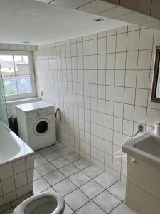 a bathroom with a toilet and a washing machine at Unterkunft Dähre in Dähre