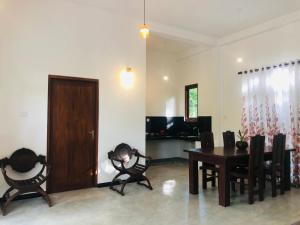 a room with a table and chairs and a dining room at Renu's House By Villa Greenery in Talpe