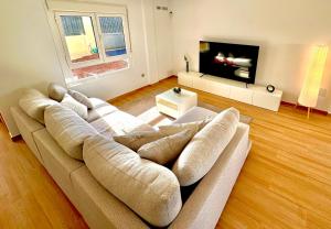 a living room with a couch and a flat screen tv at Golf villa heated pool relax tenerife south in San Miguel de Abona