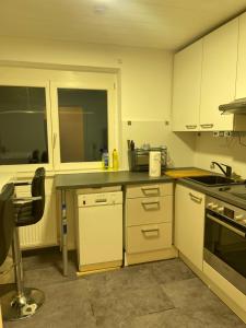 a kitchen with white cabinets and a counter top at GraceHomes (Entry to Blackforest) in Jettingen