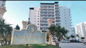 a sign for a caesar resort and spa in a city at Caesars Resort - Commodus Studio Flat in Trikomo