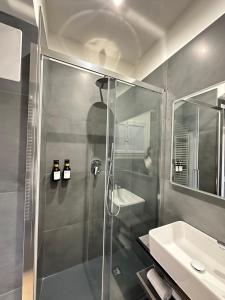 a bathroom with a shower and a sink at PB suites in Florence