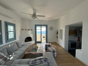 a living room with a couch and a table at Almyra Yellow Villa in Kithnos