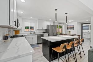a kitchen with white cabinets and a large island at Forest Haven in Ashford +24 photos