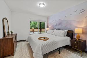 a bedroom with a bed and a large window at Forest Haven in Ashford