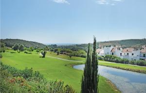 a view of a golf course with a pond at Casares Del Sol in Casares