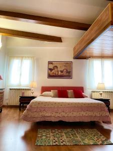 a bedroom with a large bed and two windows at The Lovely House in Perugia