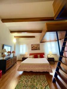 a bedroom with a large bed and some windows at The Lovely House in Perugia
