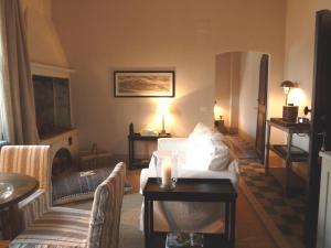 a living room with a bed and a couch at Castello di Gabiano in Gabiano