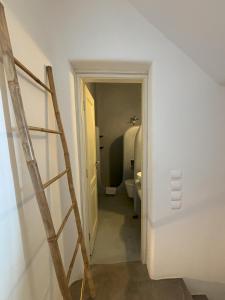 a stairway leading to a bathroom with a toilet at Almyra Red Villa in Kithnos +21 photos