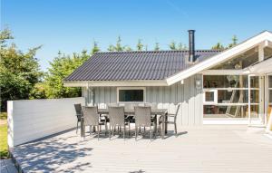 a patio with a table and chairs on it at Villa Mormor in Løkken +9 photos