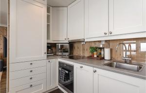 a white kitchen with white cabinets and a sink at Sjusjøen Setergrend 4724 C in Sjusjøen