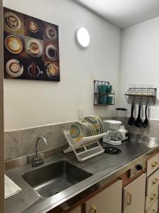 a kitchen with a sink and a counter top at Moderno y central apartamento en Arauca con aire acondicionado in Arauca
