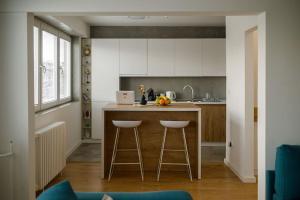 a kitchen with a counter and two bar stools at 4U Apartment in Skopje