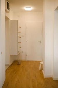 a room with a cat sitting on a wooden floor at 4U Apartment in Skopje +40 photos