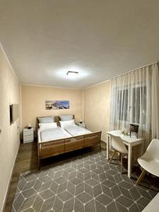 a bedroom with a bed and a table in it at Small studio for two - Ferienwohnung für Zwei in Bad Reichenhall