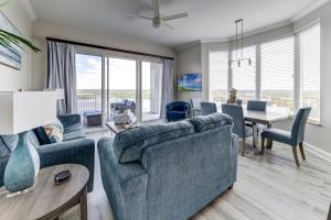 a living room with a blue couch and a table at Disney Lakefront Luxury! in Orlando