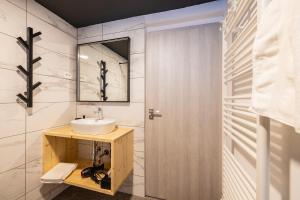 a bathroom with a sink and a mirror at Via Alpina Apartments with sauna in Mojstrana +42 photos