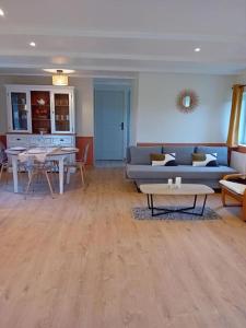 a living room with a couch and a table at Gîte La Petite Roche in Arthon