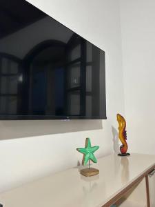 a table with a starfish and a mirror on a wall at Casa toda Equipada 900 metros da Lagoa, próxima as praias in São Pedro da Aldeia