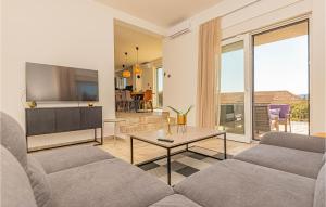 a living room with a couch and a tv at Beautiful Home In Zaboric in Zaboric