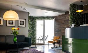 a lobby with a couch and a vase of flowers at Hotel Plaza in Pag