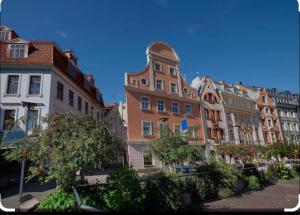 a group of buildings in a city with trees at Lux-Apartment in Medieval Part of Old Riga in Riga