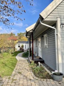 a house with a porch and a driveway at Ferienbungalow Arne am Wald in Woltersdorf