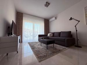 a living room with a couch and a table at 111 apartment in Čakovec