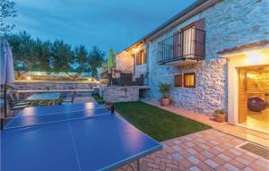 a ping pong table in the middle of a patio at Two-Bedroom Holiday Home In Jagodnja Gornja in Gornja Jagodnja +30 photos