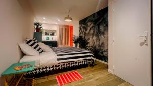 a bedroom with a bed and a table in it at Maison LeFleur - Villa avec piscine sur les hauteurs de Nice in Nice +37 photos