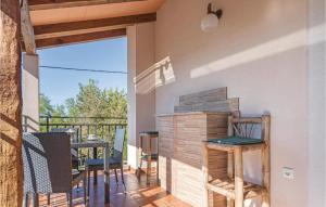a room with a balcony with a table and chairs at Holiday Home Kamena Vas Kamena Vas in Karojba