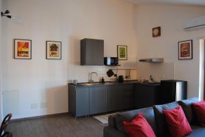 a living room with a kitchen and a couch at Vintage Apartment in Caselle Torinese