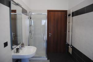 a bathroom with a sink and a shower and a toilet at Vintage Apartment in Caselle Torinese +14 photos