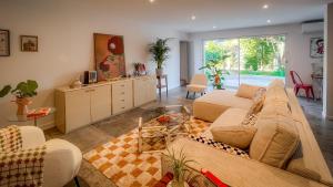 a living room with two couches and a table at Maison LeFleur - Villa avec piscine sur les hauteurs de Nice in Nice