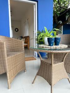a table with two chairs and a potted plant on it at Kingfisher Blues in Siolim