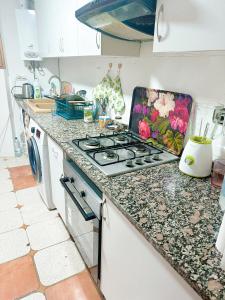 a kitchen with a stove and a counter top at Habitacion privada Valencia in Valencia